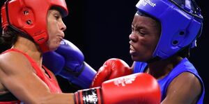 Northern Ireland's Carly McNaul (L) and Kenya's Christine Ongare fight 