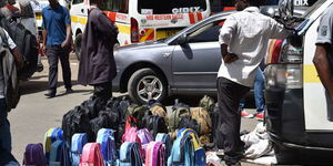 A hawker wait for customers to buy school bags along Taveta Road Nairobi