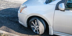 An image of a vehicle with a blown flat tyre