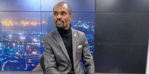 K24 crime reporter Franklin Wallah poses for a photo inside the station's studios in May 2023. 