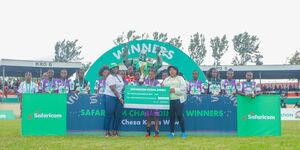 Winners of Safaricom Chapa Dimba hold a dummy cheque