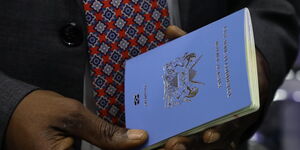 Interior CS Kithure Kindiki holding a passport on May 13, 2024