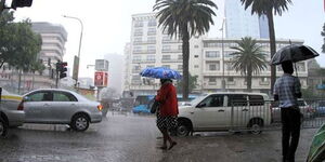Nairobi residents cross a flooded road in the Central Business District (CBD). 