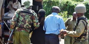 Police officers enforcing an arrest in Nairobi on February 2021.