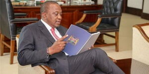 President Uhuru Kenyatta goes through the BBI report after receiving it at State House in November 2019