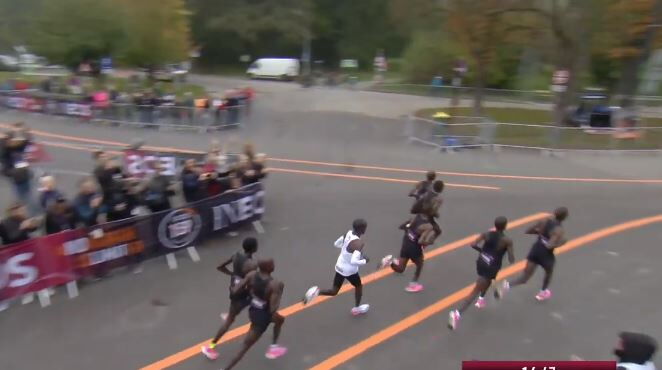 Eliud Kipchoge (white) running in Vienna, Austria in the INEOS challenge. He ran in between pace makers