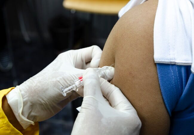 A medicine administering a vaccine