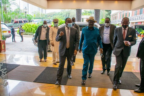ODM party leader Raila Odinga flanked by Suna East MP Junet Mohamed on Thursday, July 1.