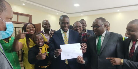 Nairobi Senator Johnson Sakaja holds his clearance certificates at IEBC offices on Tuesday, June 7.