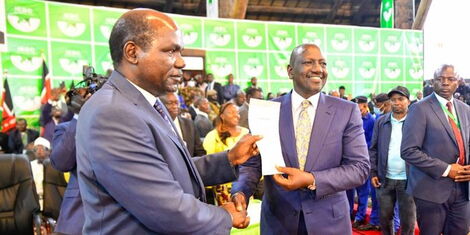 IEBC Chairman Wafula Chebukati presents President-elect William Ruto his election certificate at the Bomas of Kenya on Monday, August 15, 2022.