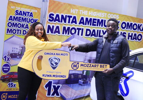 Mozzart Bet official hands over a brand new car to Lenox Shimanyula on Wednesday, December 8, 2021, after winning Omoka na Moti Promotion 