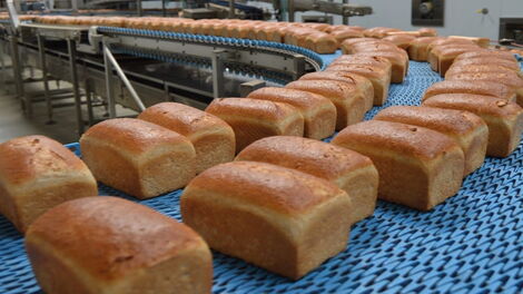 Loaves of bread being baked at a bakery