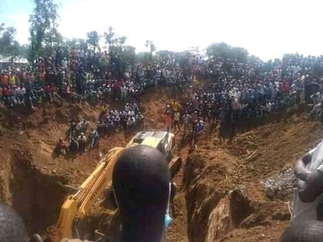 Residents of Abimbo village watch at a rescue mission to save miners trapped in the mine on December 2, 2021.