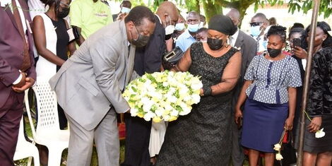 Former Vice President Musalia Mudavadi and family lay a wreath of flowers on Mama Rosebella Jerono's grave on Saturday, December 18, 2021