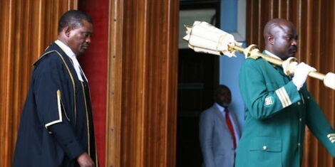 National Assembly Speaker Justin Muturi arrives in parliament in company of a Sergeant at Arms in a past session.