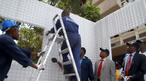Workers from the National Housing Corporation build an example of an EPS panel house in Nairobi.