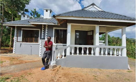 Nation FM presenter Oga Obinna poses for a photo in front of his house in Maseno, Kisumu County.