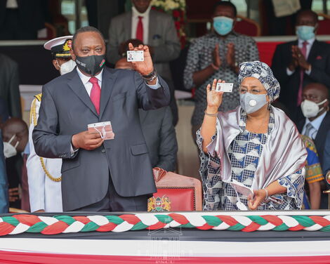 President Uhuru Kenyatta and First Lady Margaret display new Huduma Cards at Gusii Stadium on Tuesday, October 20, 2020.