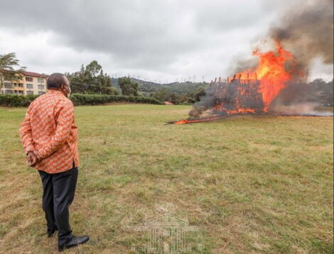 President Uhuru Kenyatta watches as 5,144 guns go up in flames at the Regional Police Traffic Training Centre in Ngong, Kajiado County.