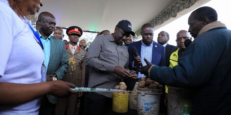 President William Ruto interacts with traders during the launch of the Hustler Fund at the Green Park terminus on Wednesday, November 30, 2022.