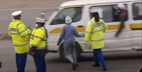 Screenshot of three Police officers and a civilian allegedly taking bribes from a matatu.