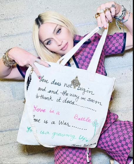 Singer Madonna posses with one of the canvas bags she handmade