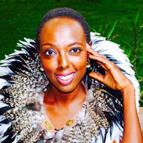 Wanja Michuki poses for a photo in traditional wear complete with bird feathers in 2018.