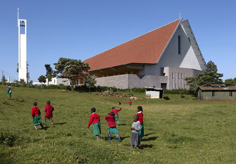 An image of children playing outside the Sacred Heart Cathedral in Kericho County.