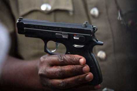 A file image of a police officer holding a pistol