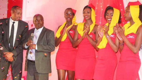Skyward Express chairman Mohamed Abdi (left) and Elgeyo-Marakwet Governor Alex Tolgos with models when the airline launched its Wilson Airport-Eldoret route on August 18, 2015 in Eldoret. 
