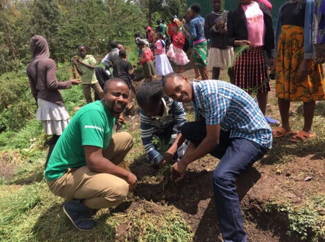 Miti Alliance founder and CEO Michael Waiyaki (left) during a tree planting activity in May 2019.