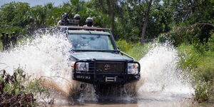 A police car in CS Kithure Kindiki's motorcade passing through stagnant water in Lamu on December 7, 2023.