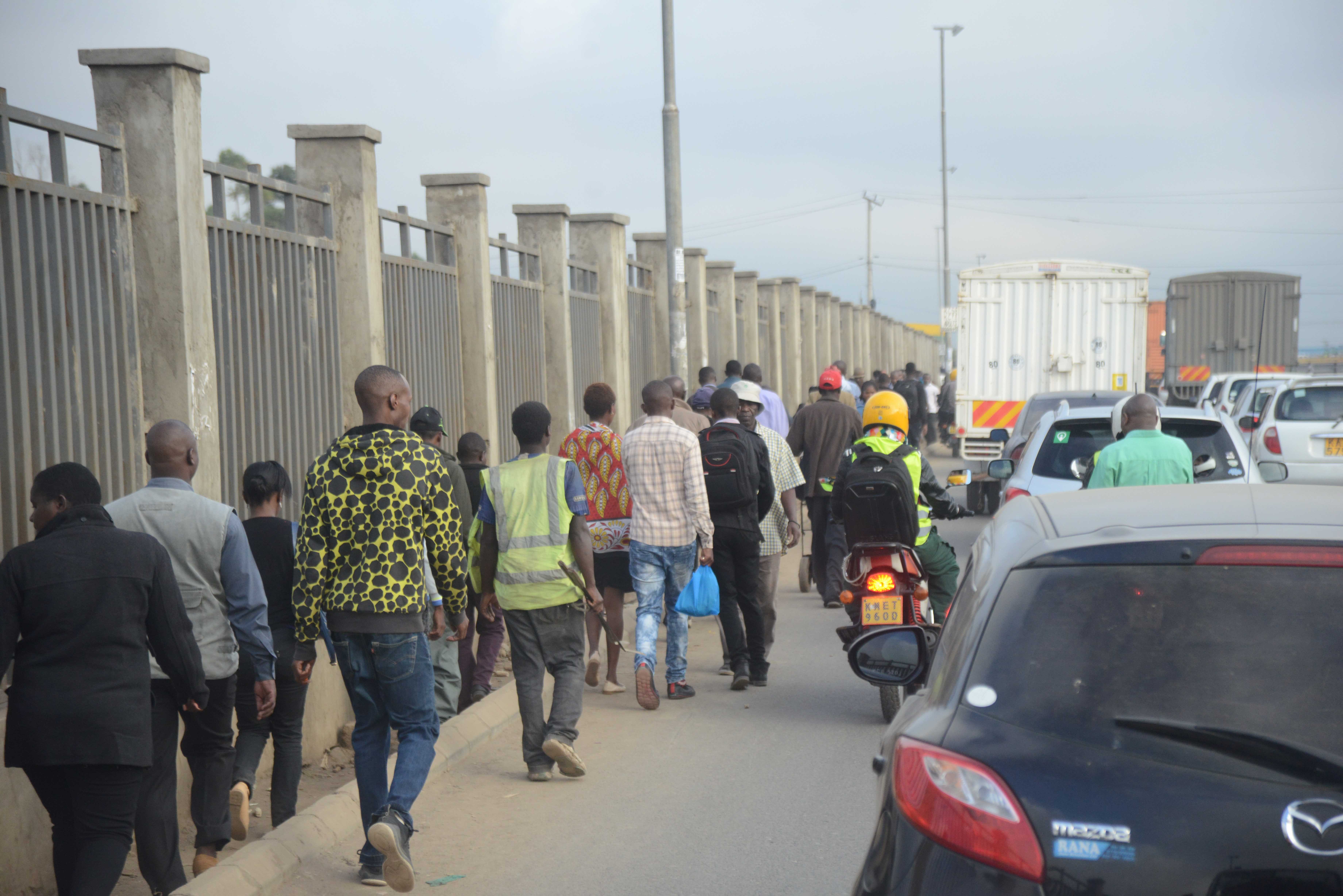 Nairobi residents walking to work due to increased cost of transport within the city.