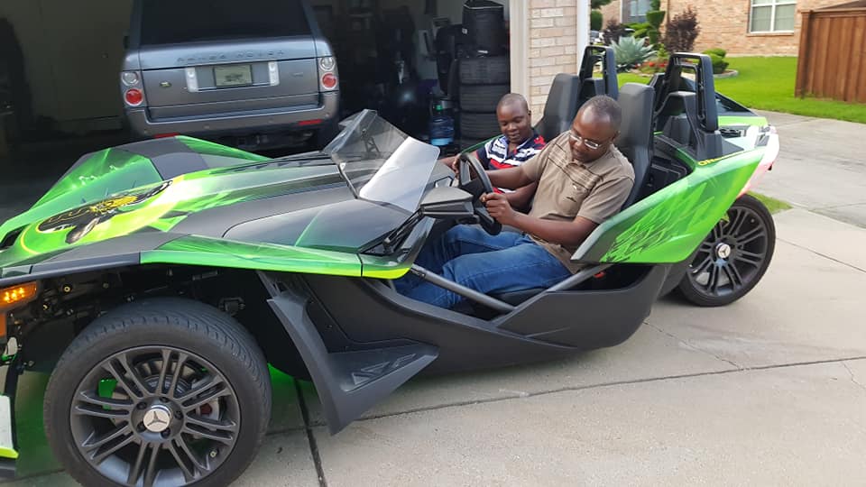 Journalist Alex Chamwada test driving a one of a kind vehicle during a shoot abroad