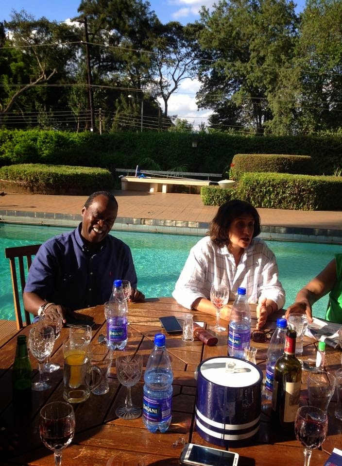 Jeff Koinange (left) attends a party at Chris Kirubi's mansion. He is seated next to the pool.