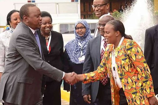 President Uhuru Kenyatta (left) greets KICC CEO Nana Gecaga.