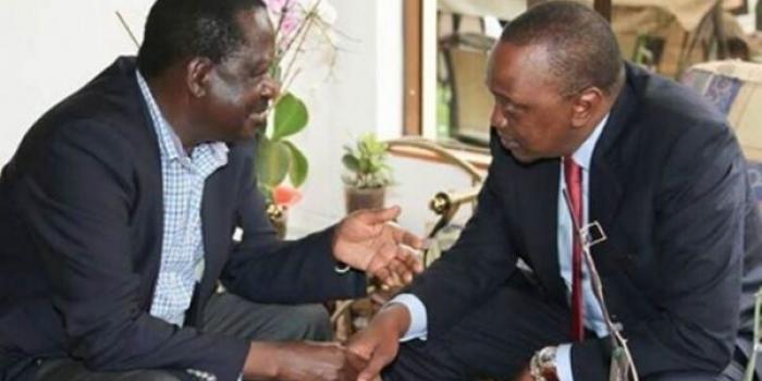 Former Prime Minister Raila Odinga (left) chats with President Uhuru Kenyatta at a past event.