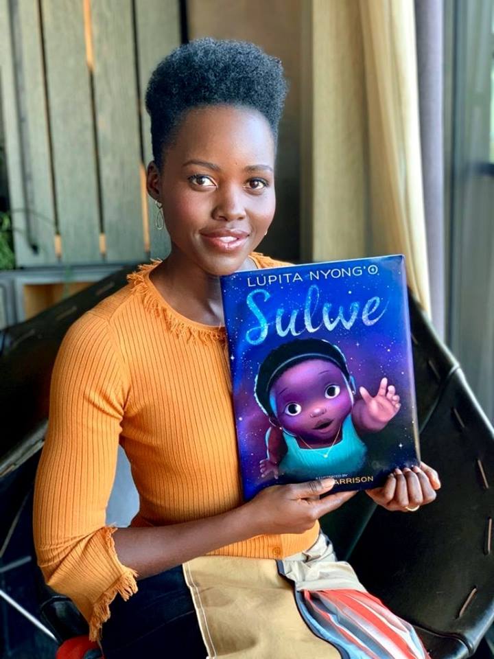 Lupita Nyong'o holding her new book 'Sulwe'.