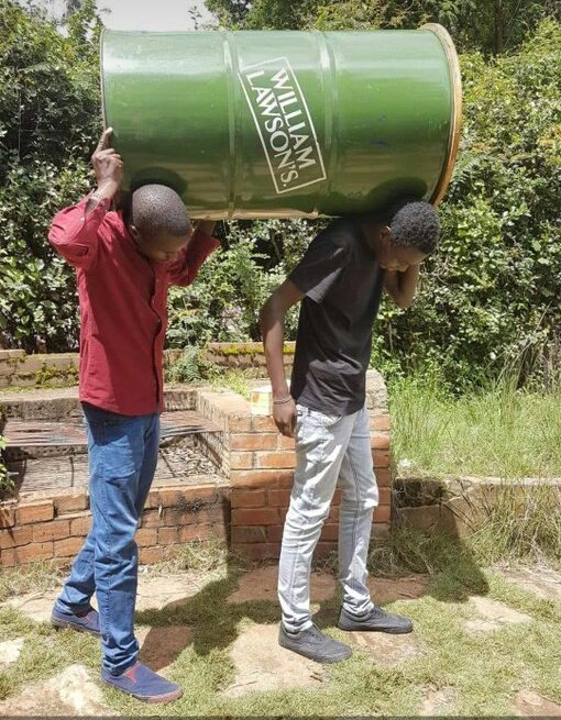 Image of two men carrying a tank containing alcohol