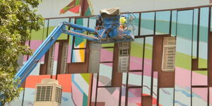 Artists working on the ExTelecom House along Haile Salassie Avenue