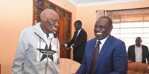 Deputy President William Ruto shares a light moment with Mzee Kibor.