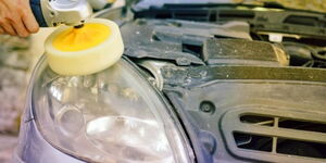 A foggy headlight being polished.