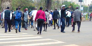 Stock image of Kenyans crossing a street in Nairobi.