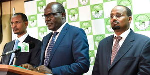 IEBC chairman Wafula Chebukati (centre) with commissioners Prof Yusuf Guliye (left) and Boya Molu, during a past press briefing at the Anniversary Towers, Nairobi.