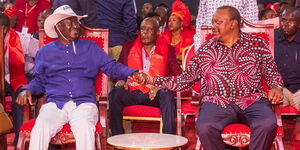 Former Prime Minister Raila Odinga holding hands with former President Uhuru Kenyatta on July 8, 2023.