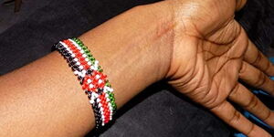 A person wearing a Kenyan wristband.