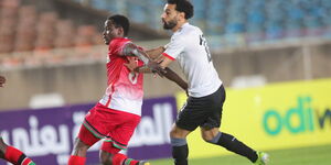 Kenyan defender Eric Ouma (left) playing against Liverpool's Mohamed Salah during a past AFCON match