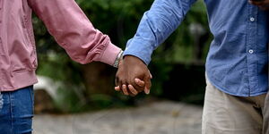 An undated image of a man holding a woman's hand.