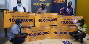 Winners of Mozzart Daily Jackpot pose with their dummy cheques