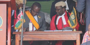 Governor Paul Otuoma signing official documents  after his inauguration as the 2nd Governor of Busia County on August 25, 2022